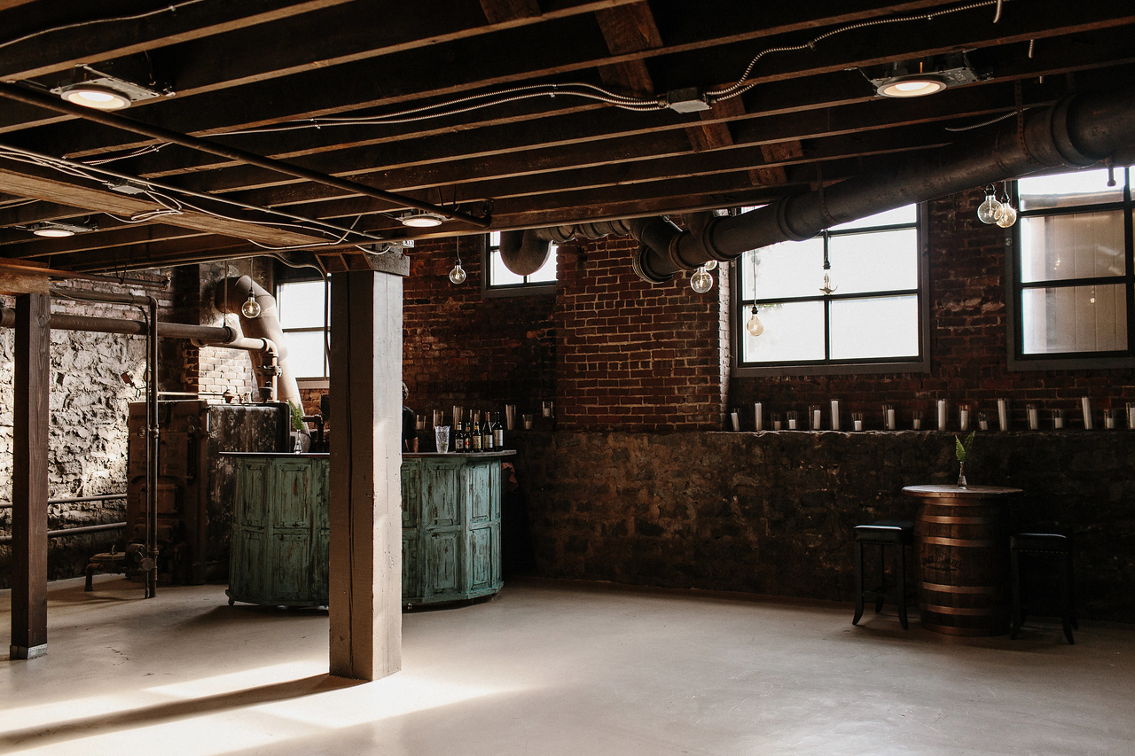 Historic brick walls and lounge seating inside Terminus 330's cellar event space.
